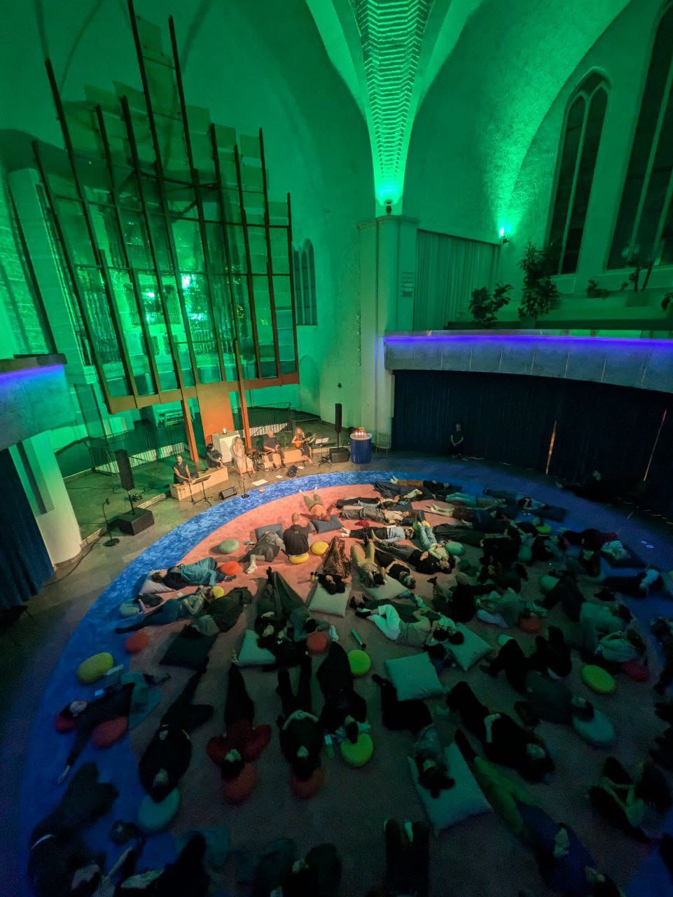 Heart Choices in a church, people resting on a large circular carpet under coloured light